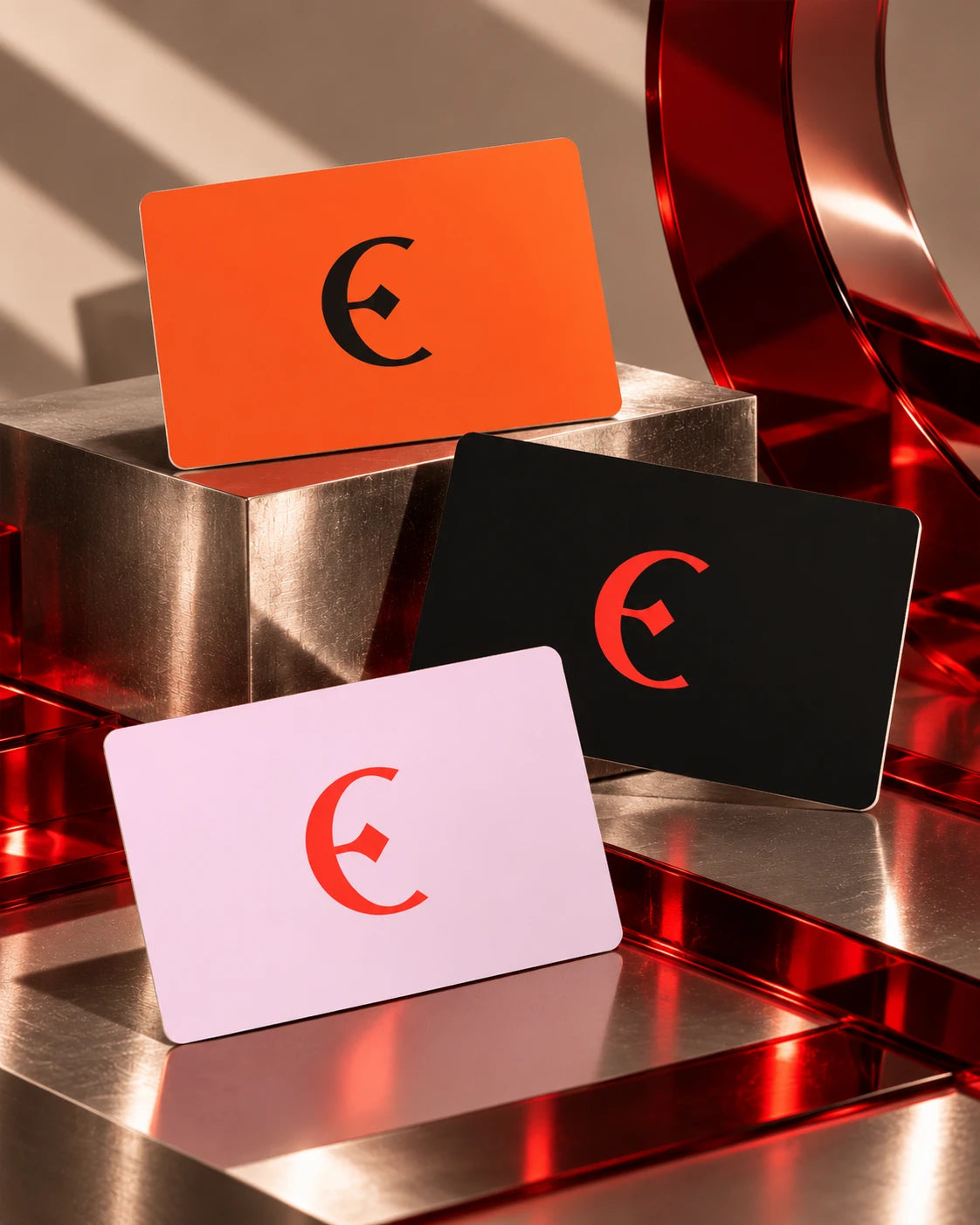 The three MORЄ gift cards in orange, black and pink